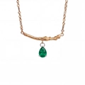 Detail of pear-cut emerald pendant with golden tree branch texture and fine cable chain - May - Green