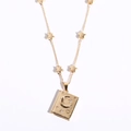 Golden celestial book pendant necklace with moon stars and rhinestones in high polish finish - Moon Star Locket Necklace / Gold