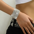 Close-up of sparkling multi-layered elastic rhinestone bracelets on a model wrist - White