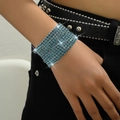Close-up of sparkling multi-row blue rhinestone stretch bracelet on woman's wrist - Teal
