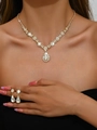 Luxurious gold-tone jewelry set featuring pear-shaped crystal necklace and earrings - Gold