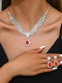 Detail of red crystal pendant necklace and earrings set worn by model on silver base - Red