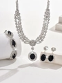 Macro shot of silver jewelry set with large oval black gemstones and pavé crystals - Necklace Bracelet Earrings (1320661) / Black
