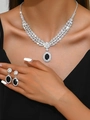 Close-up of model wearing luxury necklace and earrings set with black sapphires - Necklace Earrings (1320) / Black