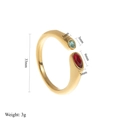 18k gold plated stainless steel open ring featuring red and blue birthstones on white background - January