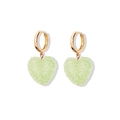 Macro detail of gold hoop earrings with light green heart-shaped sugar crystal pendants - Green Earrings