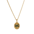 Macro shot of gold necklace with green dragonfly oval pendant and crystal accents - Dragonfly