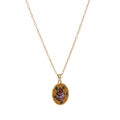 Macro shot of gold oval pendant featuring vintage rose floral pattern on yellow background - Oval Red Flower Necklace