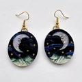 Detail of oval drop earrings with celestial moon, starry night sky, and snowy mountain design - Oval Purple Style