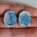 Detailed close-up of crescent moon and star resin earrings with gold glitter accents - Dark Blue Moon Star Style