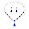 Macro shot of silver-tone necklace and teardrop blue crystal earrings jewelry set - Blue
