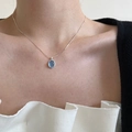 Elegant blue crystal oval pendant necklace with silver chain shown on model - Light Blue Oval Style (XL0232)