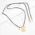 Detail of bohemian long necklace with gold sun and moon pendants on black suede cord - Sun and Moon Pendant Necklace (07629) / Gold + Black