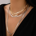 Punk style layered gold and silver snake bone chain necklaces worn by a model - 4-Layer Mixed Color Snake Bone Chain Necklace / Mixed Gold and Silver Style (6515)