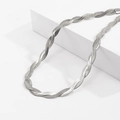 Detail view of twisted silver flat snake chain necklace with mirror-polished metallic finish - Steel Color Necklace
