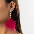 Elegant long pearl earrings with deep pink feather tassels on a female model - Gold+Red