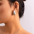 Close-up of polished silver teardrop earrings with a high-gloss finish on a female model - Polished Teardrop Stud (2951) / Silver