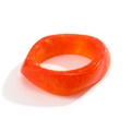 Detail of chunky orange marble resin bangle with irregular geometric acrylic texture - Orange