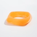 Detail of a wide square orange translucent acrylic bangle with glossy jelly texture - Orange Yellow (2252)