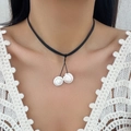Bohemian black cord necklace featuring dual natural white conch shell pendants worn by model - Necklace / Silver