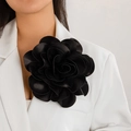 Elegant large black satin rose flower brooch and hair clip worn on a white suit - Black