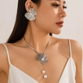 Halskette mit Ginkgoblatt und Perlenohrringen Set getragen von einem eleganten Model - Halskette + Ohrstecker Silber