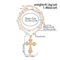 Detail of double-layer faux pearl necklace with large ornate gold cross pendant - Gold (05726)