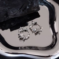 Irregular liquid silver lava geometric spiral earrings displayed on black charcoal - Irregular Spiral Style (EH0111)
