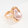 Detailed macro view of gold irregular lava ring featuring a large baroque pink pearl inlay - Pink Artificial Pearl Ring / Pink