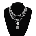 Detail of layered silver necklaces with coins on a black bust against white background - Layered Necklaces - White Gold