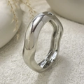 Macro detail of silver irregular wavy bangle featuring mirror polished finish and hinge - Silver Wave Style (2698-1.4cm)