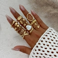 Macro view of gold-tone stackable rings set including irregular bands and heart pearl ring - Heart Artificial Pearl Bohemian Ring (6288) / 12pcs Set / Light gold