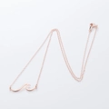 Detail of rose gold wave pendant on delicate cable chain with lobster clasp - Simple Streamline Wave (XL365) / Rose Gold