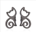 Close-up of minimalist black cat silhouette stud earrings with hollowed-out metal design - Black