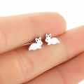Cute minimalist hollow rabbit stud earrings in silver finish shown on a finger for size - 163 Silhouette Rabbit (Silver) / 163 Silver