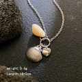 Collana d'argento con conchiglia naturale e ciondolo a cuore in stile oceanico - Argento