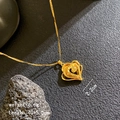 Gold brushed heart pendant necklace with layered design on volcanic rock background - Rose Heart
