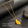 Gold leaf necklace with intricate vein texture and adjustable chain on a dark stone - Feather