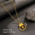 Golden dreamcatcher apple necklace with bow and bell pendant on a black background - Bell Ring