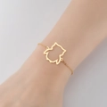 Pulsera minimalista con colgante de búho dorado y un elegante amuleto de silueta hueca - Búho Dorado