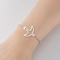 Elegante pulsera de acero inoxidable plateada con dije de pájaro hueco en cadena cruzada - Pájaro 1 Acero