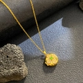 Gold photo locket necklace with green gemstone and clover design on dark stone - Round Green Zirconia Flower