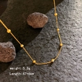 Gouden Evil Eye kralenketting, lengte 47+6cm, gewicht 5,3g op donkere steenbasis - Goud - Zeven Ogen Ketting