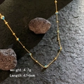 Gouden evil eye kralenketting met blauwe kralen op zwarte rots, 47+6cm - Goud - Boze Oog Kralen Ketting