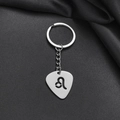Detailed macro view of silver stainless steel Leo zodiac keychain with hollow guitar pick design - Leo (005)