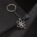 Polished stainless steel flower petal keychain charm in silver finish for backpacks - Hollow Six-Petal Flower Style (202)