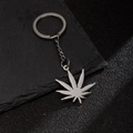 Silver stainless steel keychain with detailed palm leaf pendant on a sleek dark surface - Cannabis Leaf Shape (200)