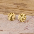 Detail of gold mandala flower stud earrings with intricate cutout petals on stone - Gold