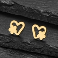 Close-up of gold heart-shaped stud earring with flower detail on black rock background - Gold
