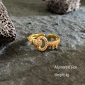 Adjustable key-shaped gold ring with light pink cubic zirconia on a volcanic rock base - Zirconia Encrusted Key Open Ring / Gold